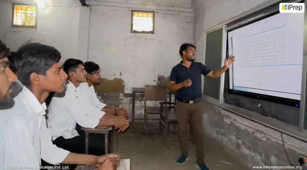 A teacher using a preinstalled learning platform, iPrep, on a 65-inch interactive flat panel (IFP) setup by iDream Education to teach a classroom of students.